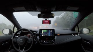A Self-Driving Car Quickly Drives Through A Heavy Rainstorm