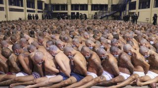 [Pics] Prisoners Stripped Half-Naked, Sitting Tightly In Lines Despite Social-Distancing Order Amid COVID-19