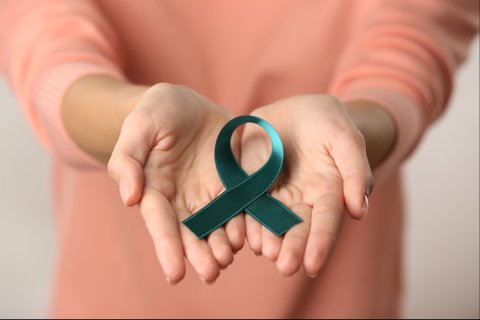 Woman Holding Cervical Cancer Ribbon
