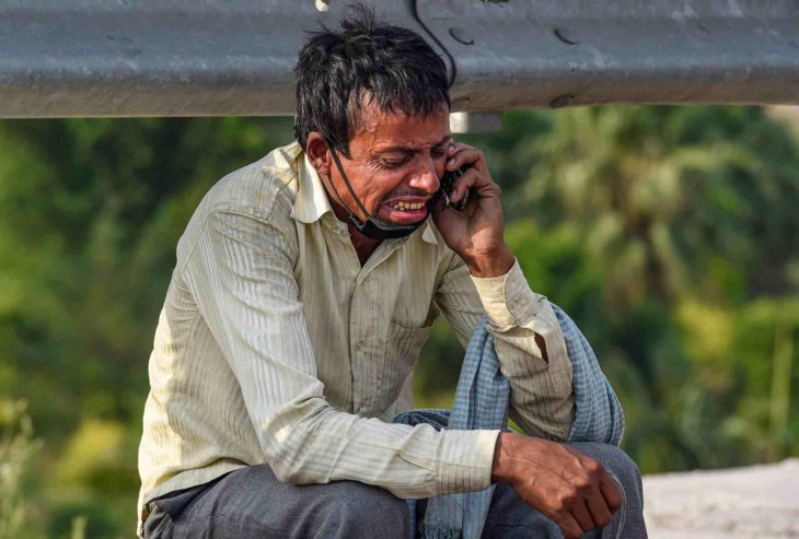 Rampukar Pandit, 38 years old, on the phone with his wife