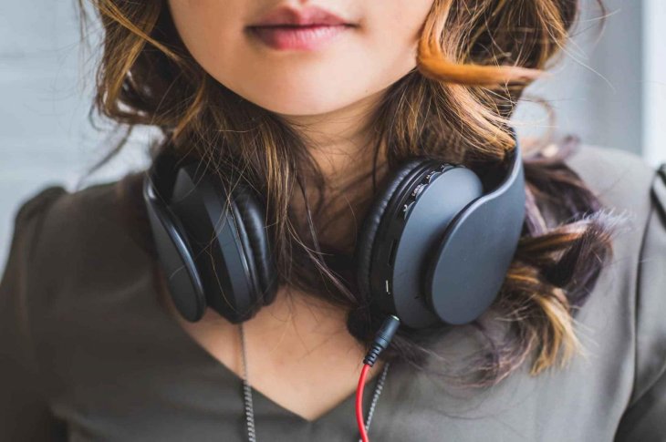Girl Wearing Wired Headphones Wondering About Radi